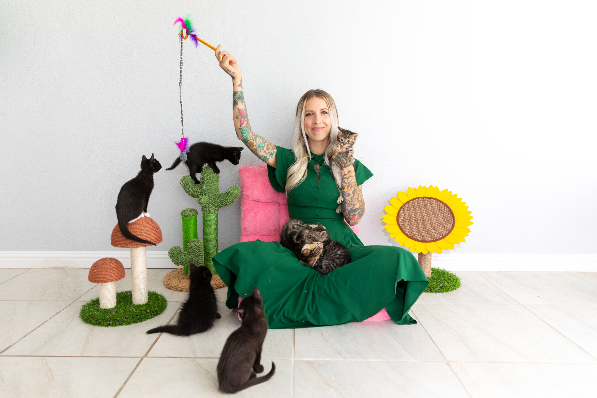 Kitten Lady Sitting in Green Dress with Kittens in Her Lap